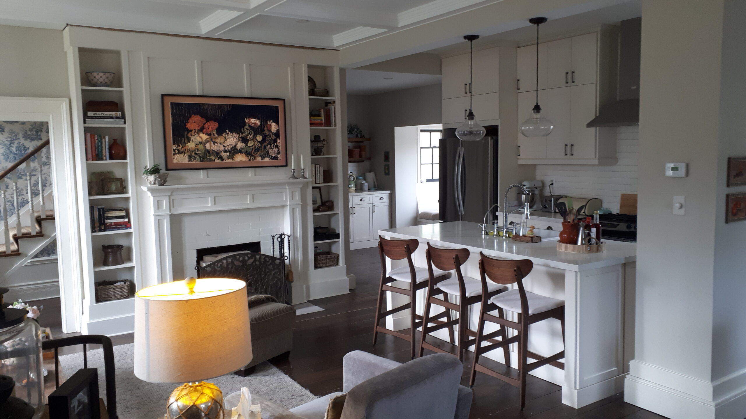 custom built in fireplace surround in great room with kitchen island